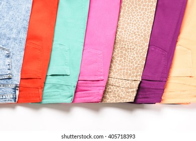 A Number Of Colored Jeans Isolated On White Background