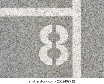 Number eighth painted on soft rubber surface. The eighth. Jumping hopscotch game with numbers. Safety outdoor playground