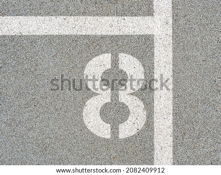Number eighth painted on soft rubber surface. The eighth. Jumping hopscotch game with numbers. Safety outdoor playground
