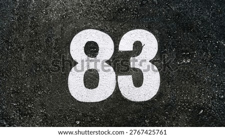 Number eighty three, 83 on black asphalt                   