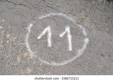 Number Eleven Spray Painted On Tarmac Path Inside Circle 