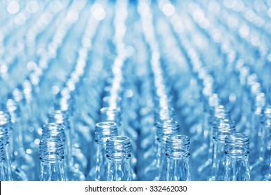Number empty glass bottles on conveyor with blurred background