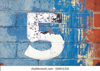 The Number Five Painted On A Carpark Wall