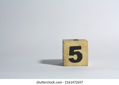 Number Five In Wooden Cube On Plain White Background Isolated