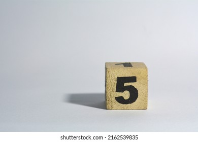 Number Five In Wooden Cube On Plain White Background Isolated