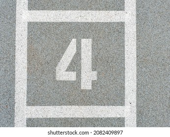 Number four painted on soft rubber surface. Jumping hopscotch game with numbers. Safety outdoor playground. Fourth possition.