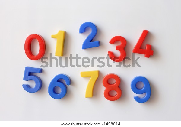 number\
fridge magnets displaying numbers 0 - 9,\
messy