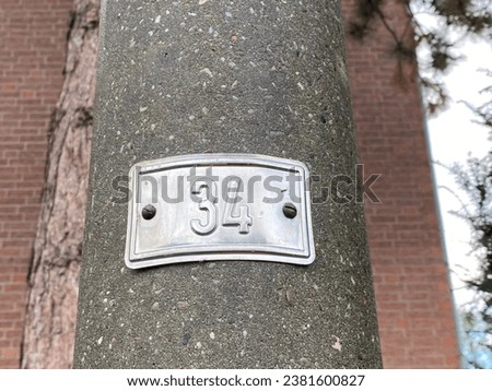 number on a metal plate on a pole