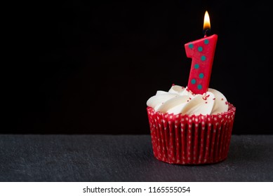 Number one candle on red birthday cupcake