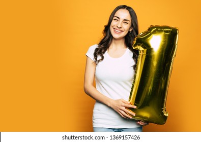 Number One. A Girl With A Soul Of A Child Is Happy Because Of Beautiful Gold Balloon In Her Hands And We Can See It Through Her Pleased Smile.