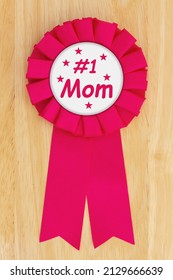 Number One Mom Pink Ribbon On A Wood Desk For Your Mother’s Day Or Thank You Message