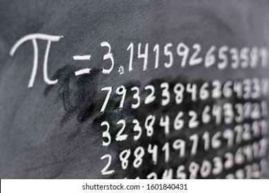 The number pi written with chalk on the blackboard, with its equivalence in numbers
