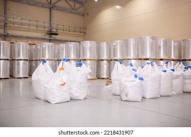 A Number Of Rolls Of Aluminum Lies In The Production Shop Of The Plant. Metal Processing, Aluminum Plant. Bags With Recycled Raw Materials Are Recycled.