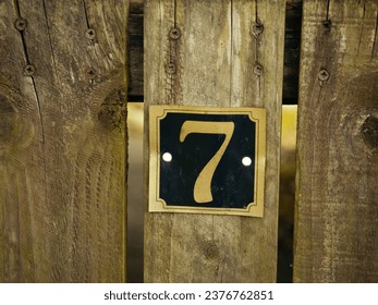 Number seven on a house gate post close up shot selective focus