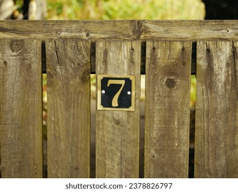 Number seven on a house gate post medium shot selective focus