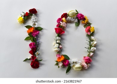 Number ten made of natural flowers and leaves. Floral numerical concept. Creative idea for spring, summer, birthdays and anniversaries.