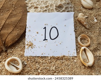 Number ten writting on beach sand background. - Powered by Shutterstock