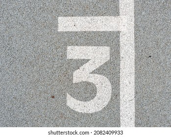 Number three painted on soft rubber surface. Jumping hopscotch game with numbers. Safety outdoor playground. The third possition. 