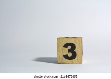 Number Three In Wooden Cube On Plain White Background Isolated