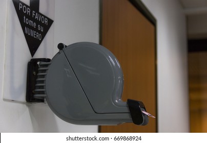 Number Ticket Dispenser Machine At Clinic Reception Room. Spanish Language Translation: Please Take A Number. Bureaucracy, Administration Office, Get In Line, Waiting Concept