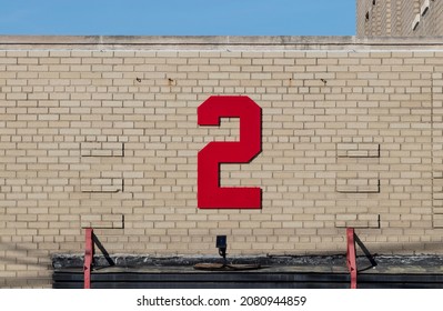 Number two in bold, red text against a beige brick background. - Shutterstock ID 2080944859