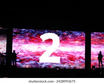 Number two of a countdown from ten to zero, this is the number two projected on a screen with many colors.