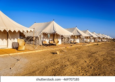 A number of white tents in Indian Thar desert, Desert national Park, blue sky and yellow sand in daylight, copy space