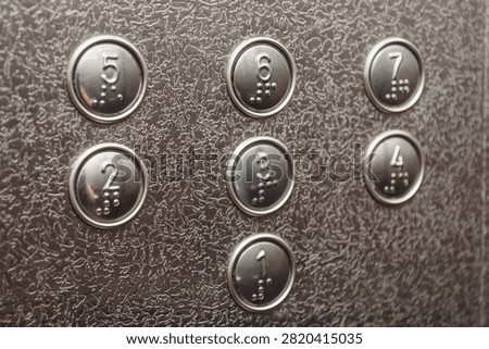 numbered floor buttons in elevator of multi-storey building