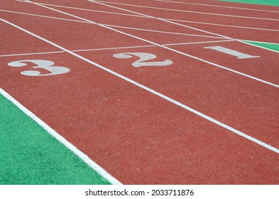 The Numbers 1,2,3 On The Running Track. Red Jogging Tracks At The Stadium. Sports, Active Lifestyle. Selective Attention.