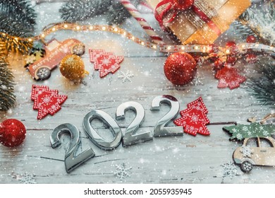 numbers 2022 on a wooden background with Christmas decorations and snowflakes. selective focus