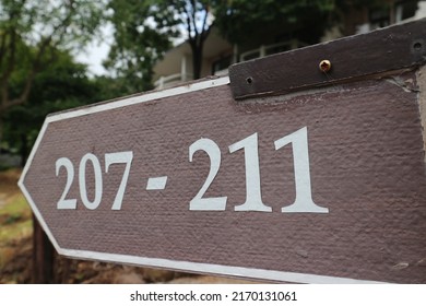 Numbers On A Plaque Pointing The Way To A Hotel Room, Resort.