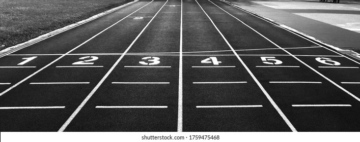 Numbers On Red Running Track. Start And Finish Point Of A Race Track In A Stadium(Black And White Photo)