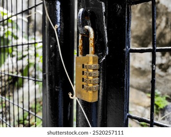The numeric code padlock locks the iron gate door.