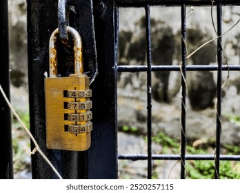 The numeric code padlock locks the iron gate door.