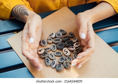Numerology Numbers Concept. Numerology Calculate Life Path and Destiny Numbers. Many pebble stones with painted numbers in female hands