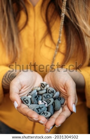 Numerology Numbers Concept. Numerology Calculate Life Path and Destiny Numbers. Many pebble stones with painted numbers in female palms Stock photo © 