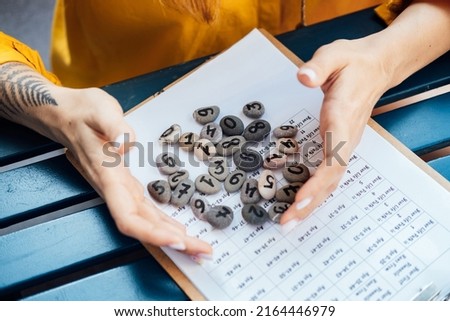Numerology Numbers Concept. Numerology Calculate Life Path and Destiny Numbers. Many pebble stones with painted numbers in female hands Stock photo © 