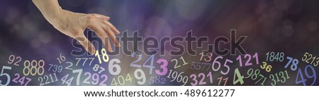 Numerology Wide Bokeh Website Banner - dark multicolored bokeh background with transparent numbers randomly placed along the bottom and a female hand choosing the number 18