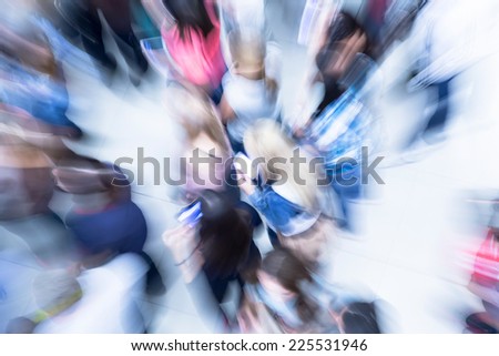 Numerous blurry people representing urban environment and everyday rush