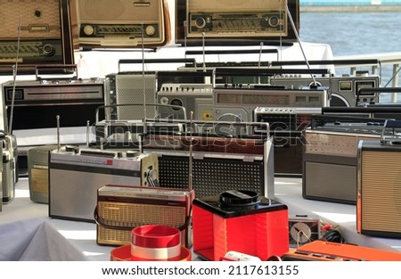 The numerous old radios on a flea market