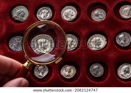 Numismatics.Authentic silver denarius, antoninianus of ancient Rome. A collector holds an old coin.Ancient coin of the Roman Empire