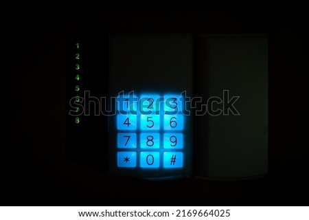 Numpad of remote control panel of the security system in the apartment. activating a modern alarm system before leaving home