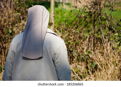 A Nun In Grey Robe In The Forest. A Game Of Light And Shadow. Religion And Nature. Meditation Background. Harmony, God In Nature Idea.