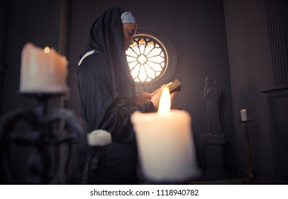 Nun praying in a monastery