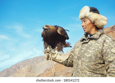 NURA, KAZAKHSTAN - FEBRUARY 23: Eagle on man's hand in Nura near Almaty on February 23, 2013 in Nura, Kazakhstan. The traditional event happens yearly and the place becomes as a medieval times city.