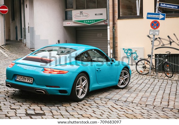 Nuremberg, December 27: blue Porsche car next to\
the garage of Durer\
Hotel.