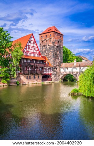Nuremberg, Germany. Colourful and picturesque view of the half-timbered old houses on the banks of the Pegnitz river, Maxbrucke Bridge. Travel landmark of Franconia, Bavaria.