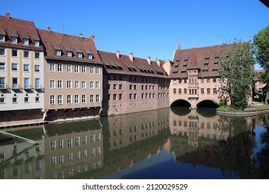 Nuremberg Landmark In Germany. Holy Spirit Hospital (Heilig-Geist-Spital) On River Pegnitz. Medieval Landmark.