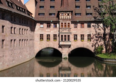 Nuremberg Landmark In Germany. Holy Spirit Hospital (Heilig-Geist-Spital) On River Pegnitz. Medieval Landmark.