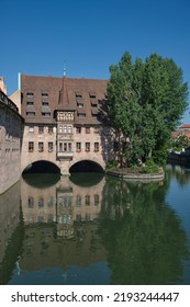 Nuremberg Landmark In Germany. Holy Spirit Hospital (Heilig-Geist-Spital) On River Pegnitz. Medieval Landmark.